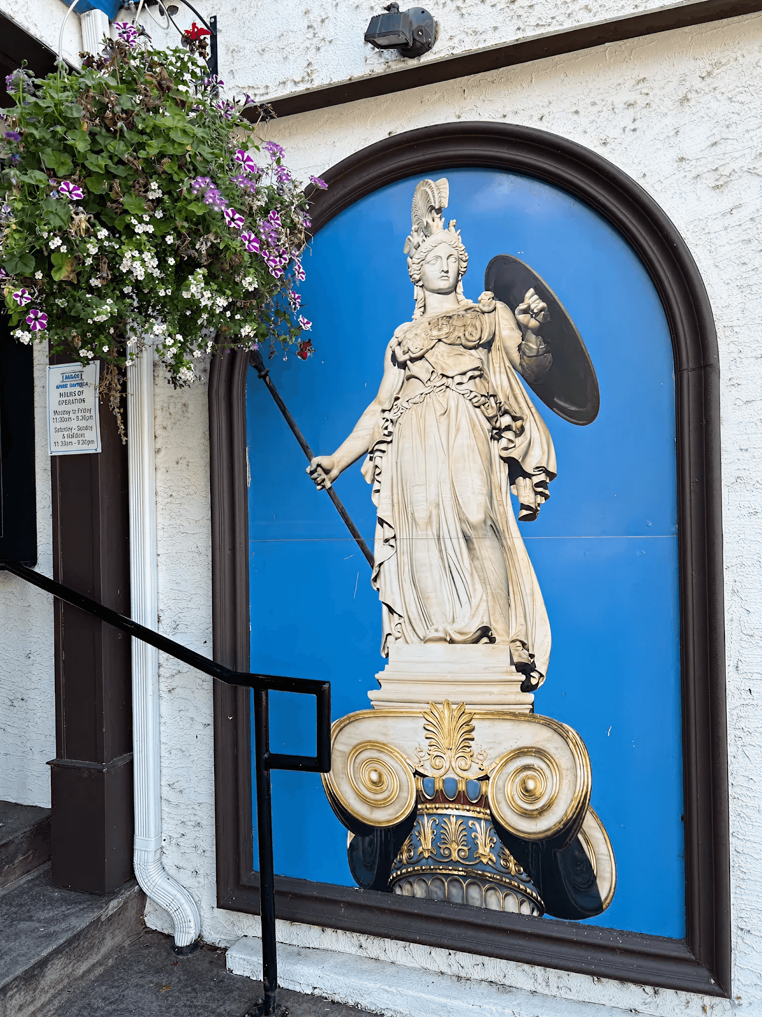 Greek statue framed in a blue arched window
