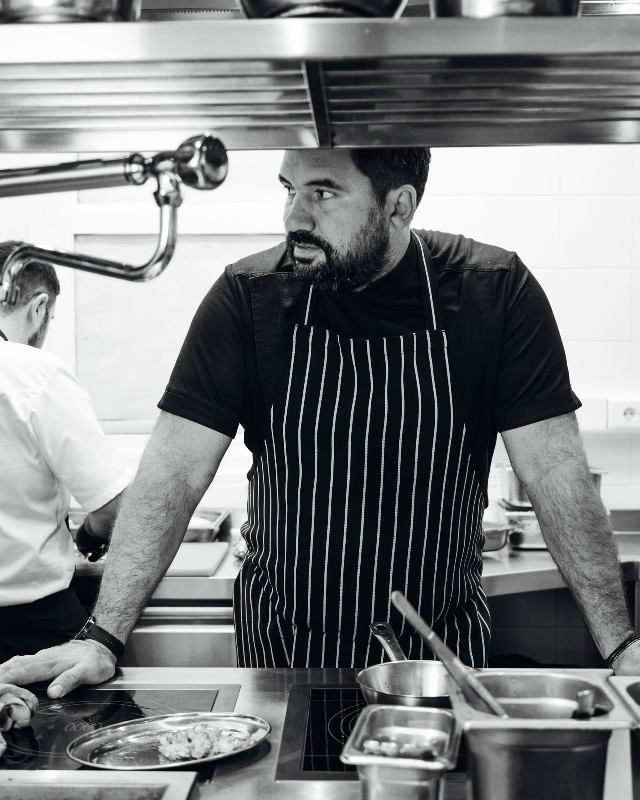 A Milos chef plating in the kitchen